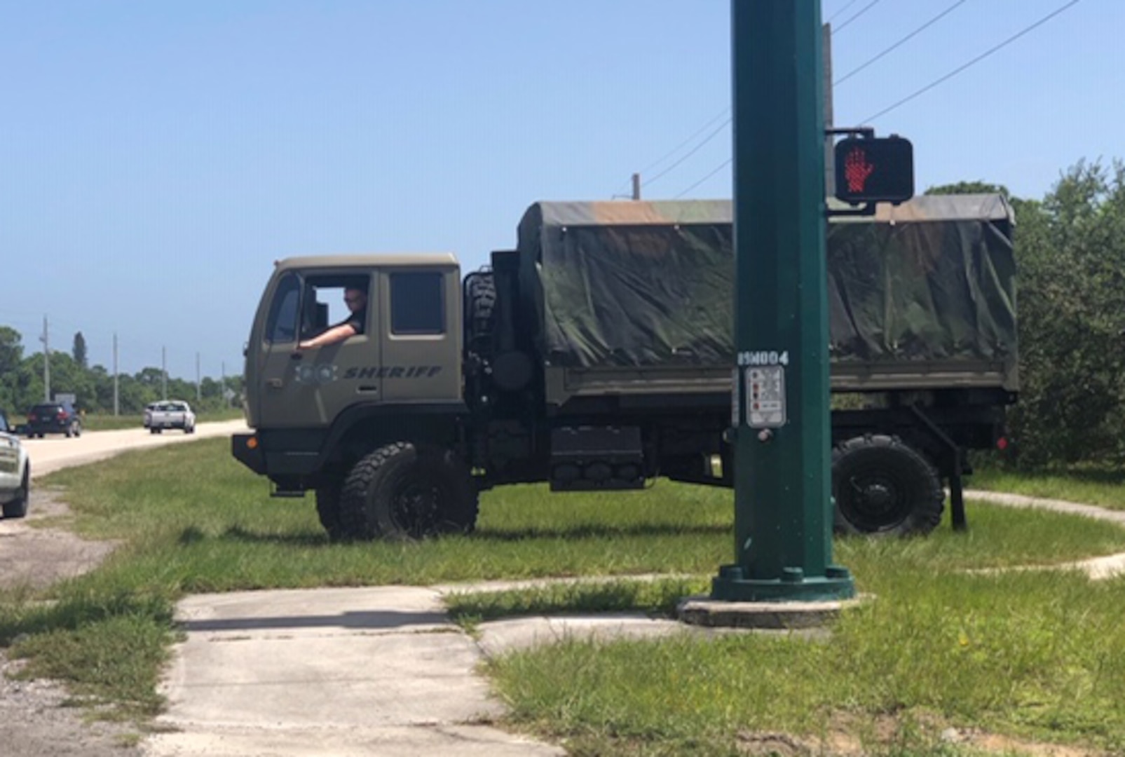 A former military truck .sits along a roadside
