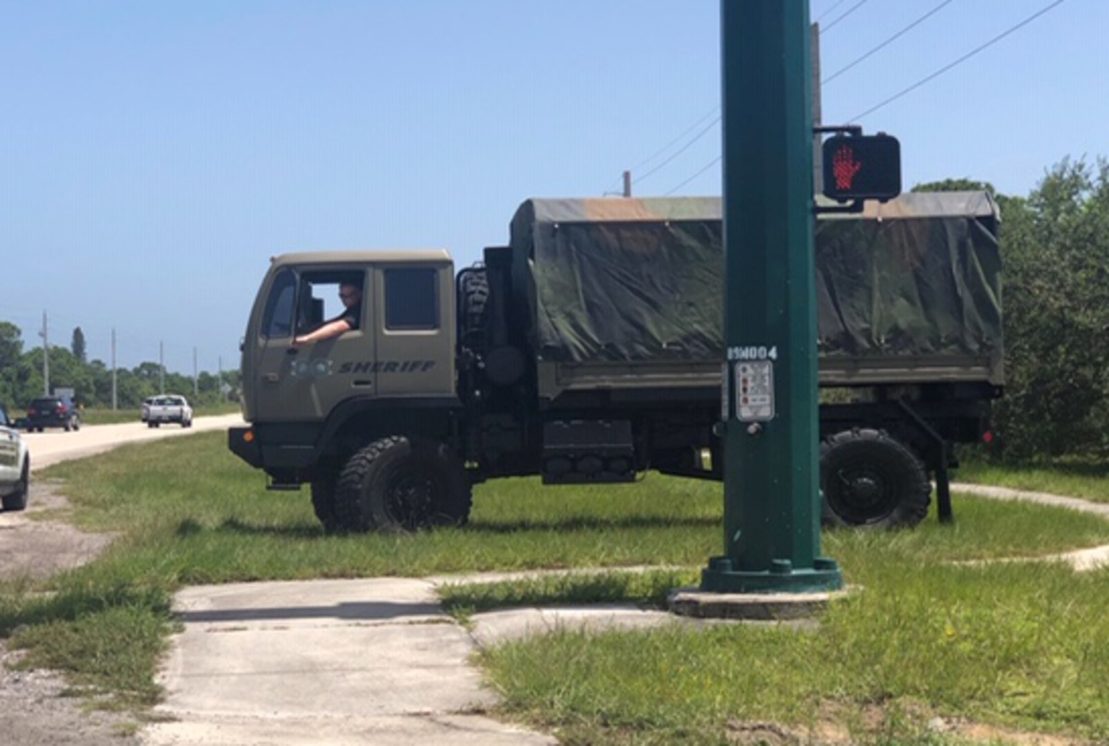 A former military truck .sits along a roadside