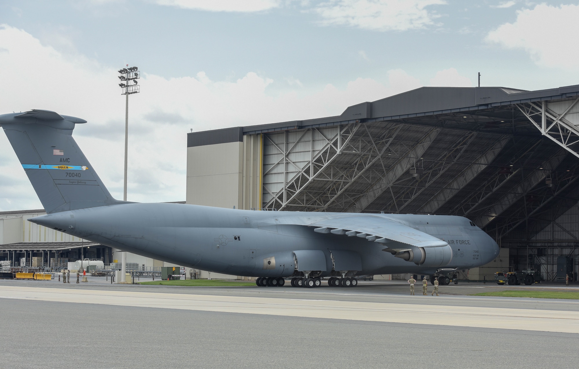 A C-5M Super Galaxy is towed into an aircraft hangar, Aug. 3, 2020, Dover Air Force Base, Delaware. In response to Tropical Storm Isaias, Dover AFB evacuated 14 aircraft in less than 24 hours, ensuring sustained readiness for the base's rapid global airlift mission. (U.S. Air Force photo by Senior Airman Eric Fisher)
