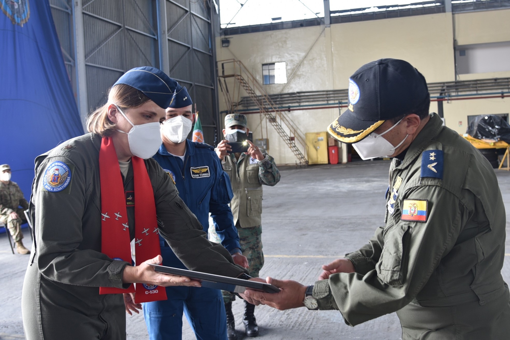 U.S. Air Force Maj. Noelle DeRuyter, 571st Mobility Support Advisory Squadron mission commander, presents the commander of the Fuerza Aérea Ecuatoriana’s 11th Transportation Wing, Lt. Col. Jorge Alcázar Sevilla, a commemorative plaque from the 20-10 Mobile Training Team July 31, 2020, at Cotopaxi Air Force Base in Latacunga, Ecuador. (U.S. Air Force photo by Master Sgt. Freddy Muñoz)