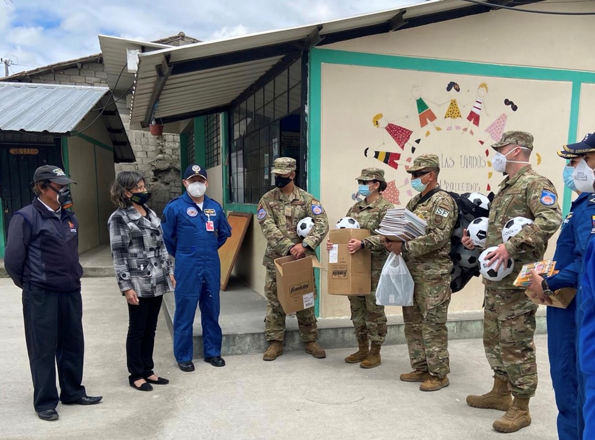 Members of the Fuerza Aérea Ecuatoriana and the U.S. Air Force’s 571st Mobility Support Advisory Squadron Mobile Training Team deliver school supplies and soccer balls July 30, 2020, to a local school near Latacunga, Ecuador. (U.S. Air Force photo by Tech. Sgt. James Garcia Arvelo)