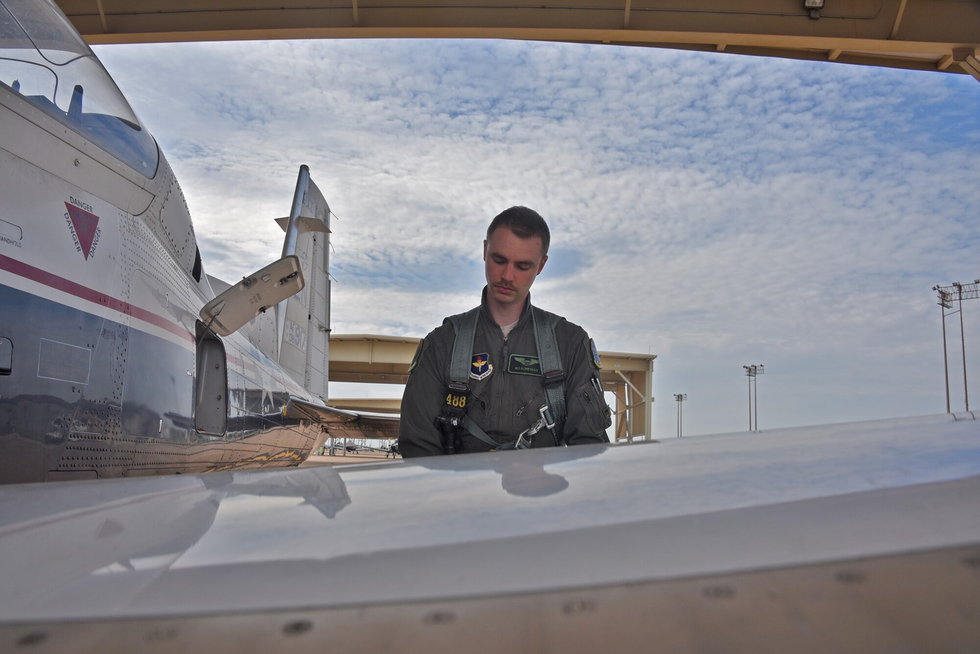 First Lt. Ralph “Bo” Korpman looks over an Air Force plane before takeoff.