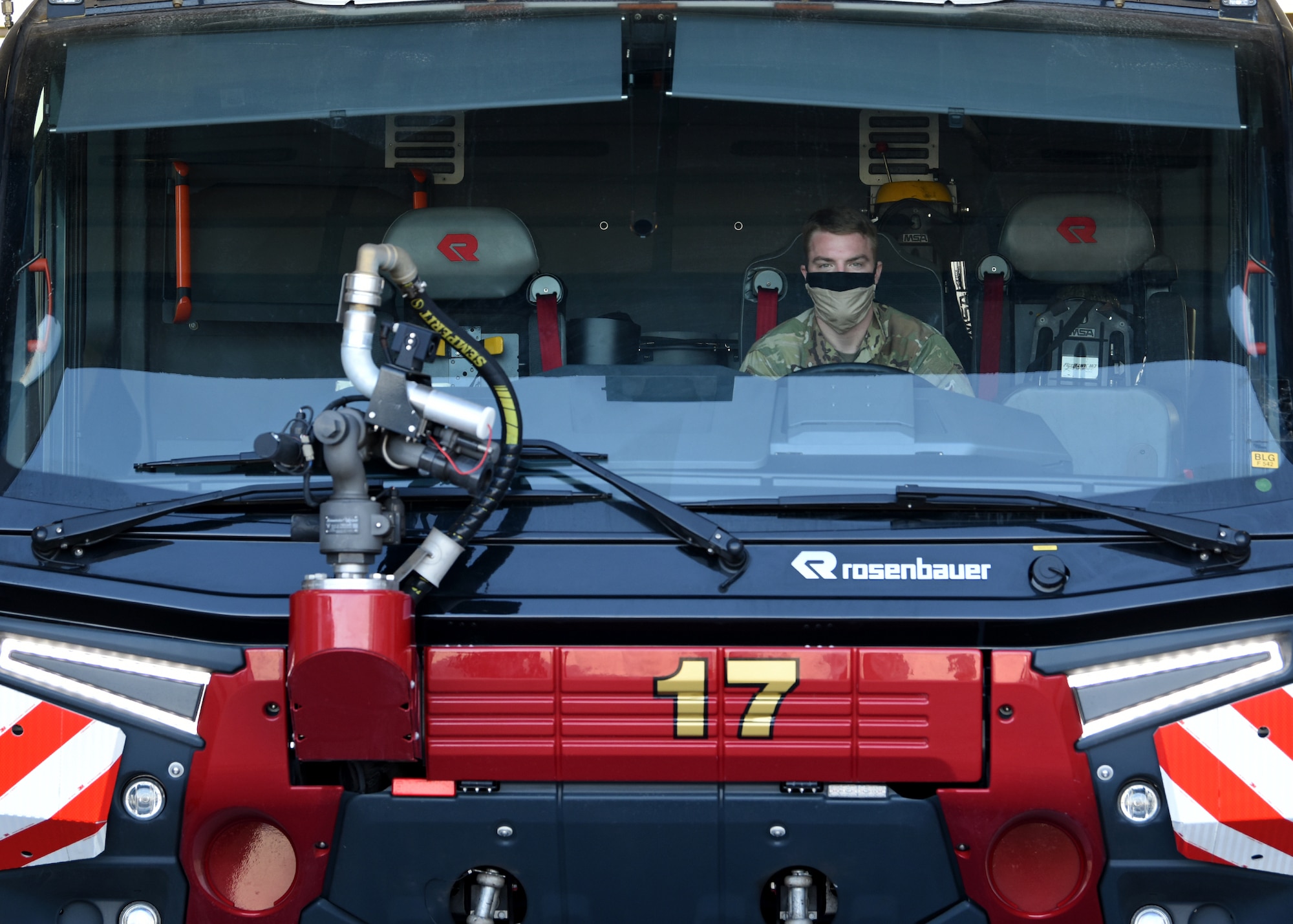 photo of a U.S. Air Force Airman sitting inside a fire truck