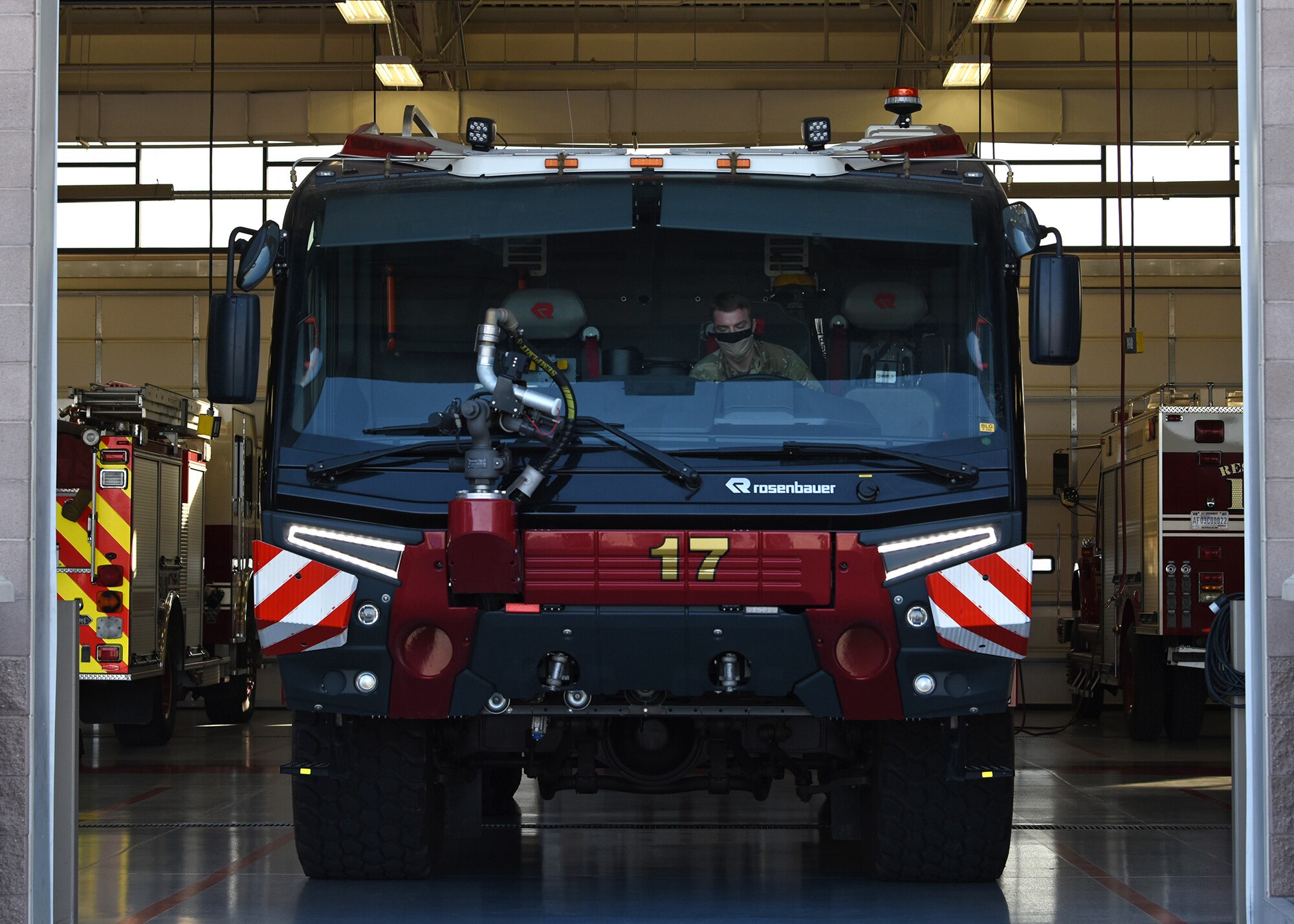 photo of a U.S. Air Force Airman sitting inside a fire truck
