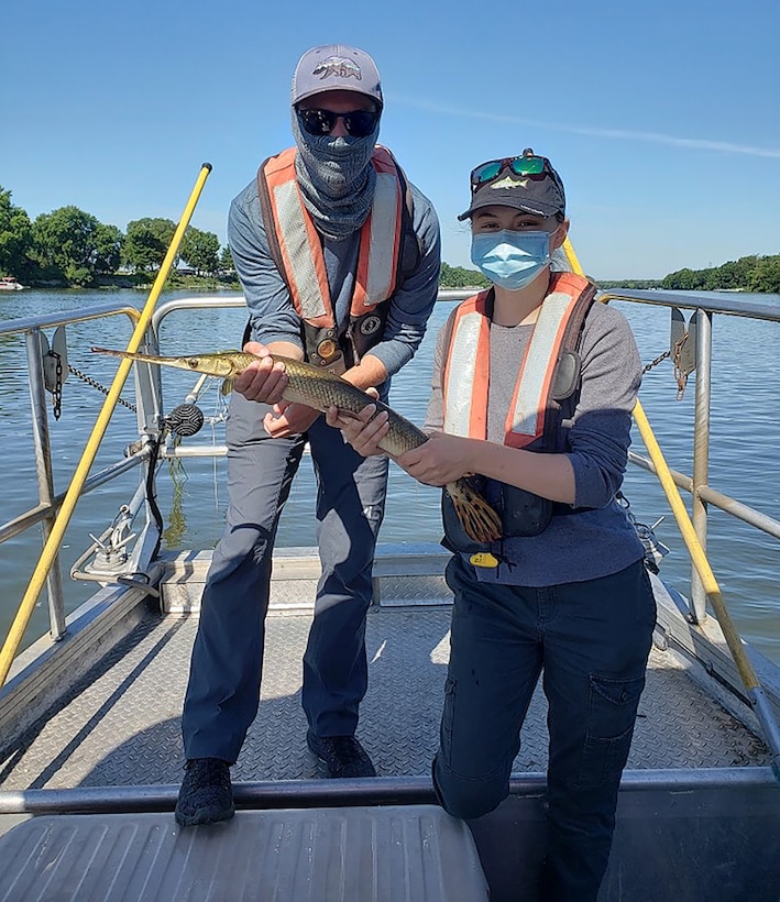Summer hires Dayla Dillon and Joshua Jacobs pose with a longnose gar while electrofishing along the Kankakee River.