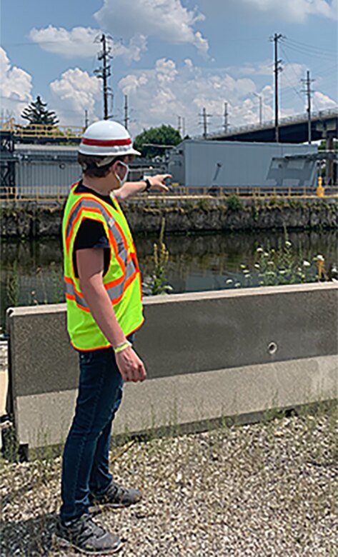 Lucas Beasley, summer hire, speaks to another intern about battery backup at the Chicago Sanitary and Ship Canal’s electric fish barrier site.