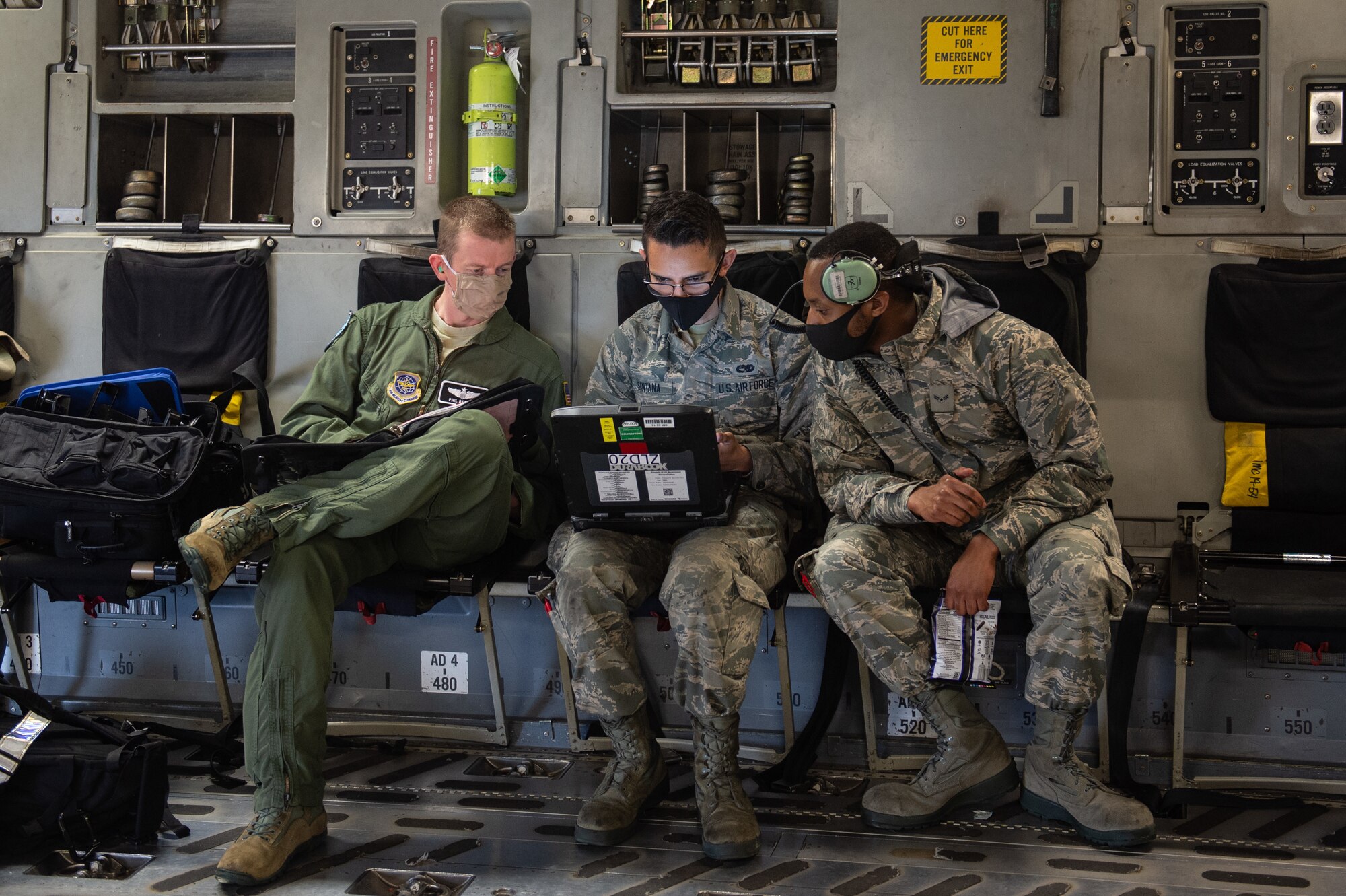 Maj. Philip Becker, 8th Airlift Squadron pilot, left, works with 62nd Aircraft Maintenance Squadron Airmen to complete preflight checks