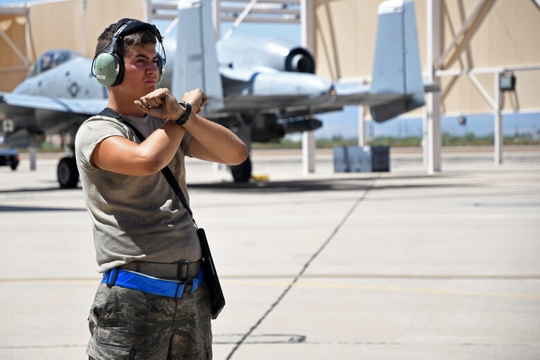 a photo of an airman standing on the flightline
