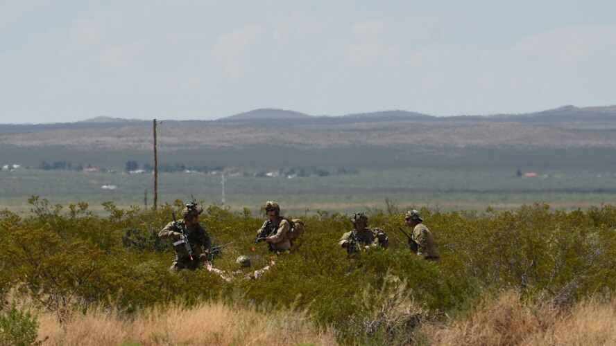 photo of Air Force rescue Airmen rescuing a simulated downed pilot during a training scenario