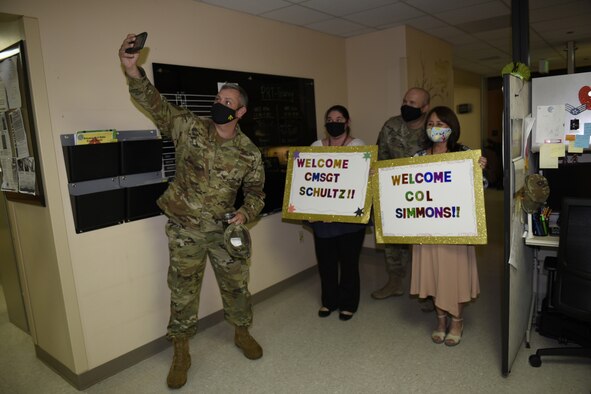 U.S. Air Force Col. Corey Simmons, 60th Air Mobility Wing commander, takes a photo with Yoko Schlafer, left, 60th Medical Support Squadron service treatment record manager, Chief Master Sgt. Robert Schultz, center, 60th AMW command chief, and Donna Murant, 60th MDSS release of information technician, during Leadership Rounds Aug. 14, 2020, at Travis Air Force Base, California. The Leadership Rounds program provides 60th AMW leadership an opportunity to interact with Airmen and get a detailed view of each mission performed at Travis AFB. (U.S. Air Force photo by Airman 1st Class Cameron Otte)
