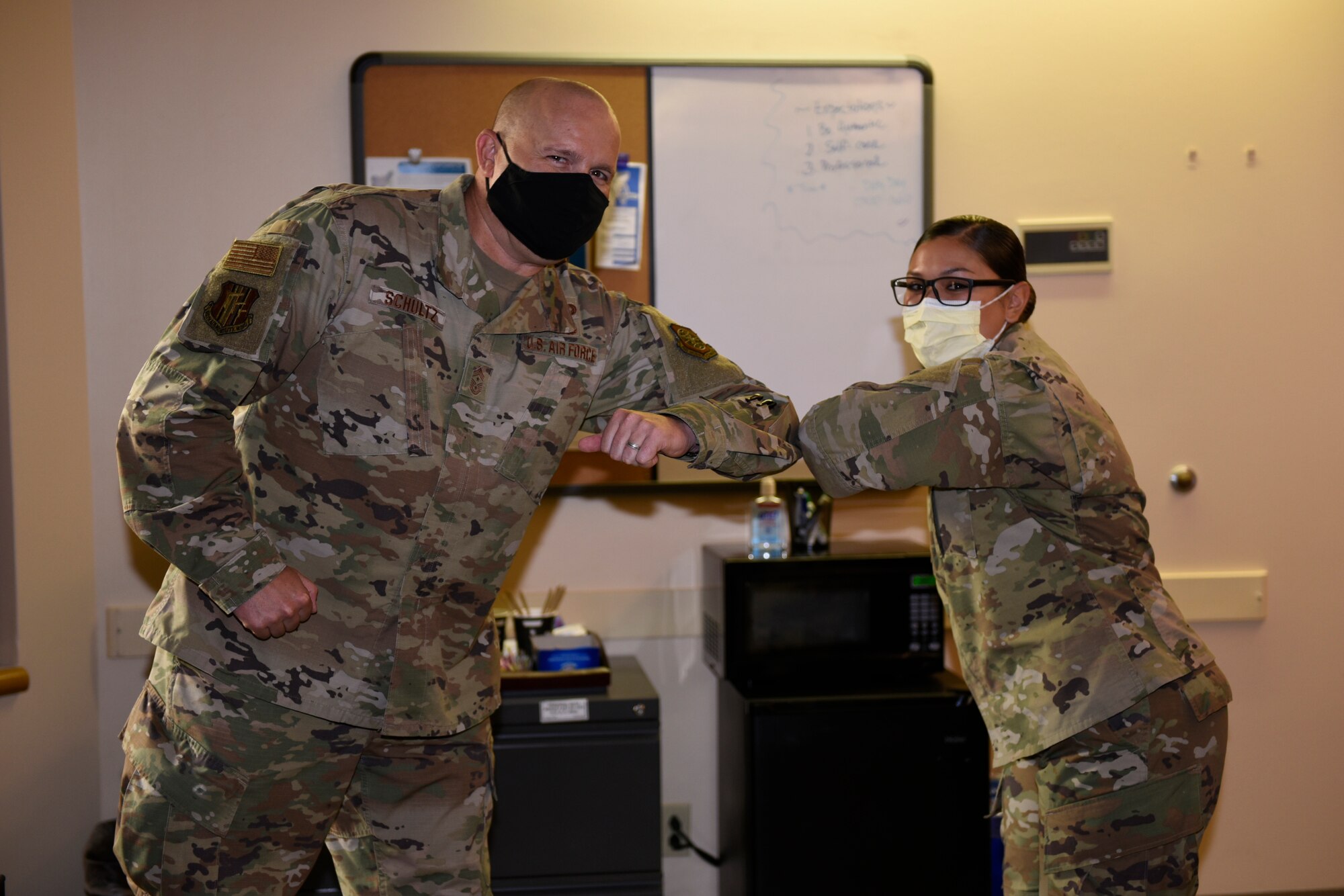 U.S. Air Force Chief Master Sgt. Robert Schultz, left, 60th Air Mobility Wing command chief, recognizes Senior Airman Melissa Shaffer, 60th Medical Support Squadron Airmen Medical Transition Unit noncommissioned officer in charge, as a star performer during Leadership Rounds Aug. 14, 2020, at Travis Air Force Base, California. The Leadership Rounds program provides 60th AMW leadership an opportunity to interact with Airmen and get a detailed view of each mission performed at Travis AFB. (U.S. Air Force photo by Airman 1st Class Cameron Otte)