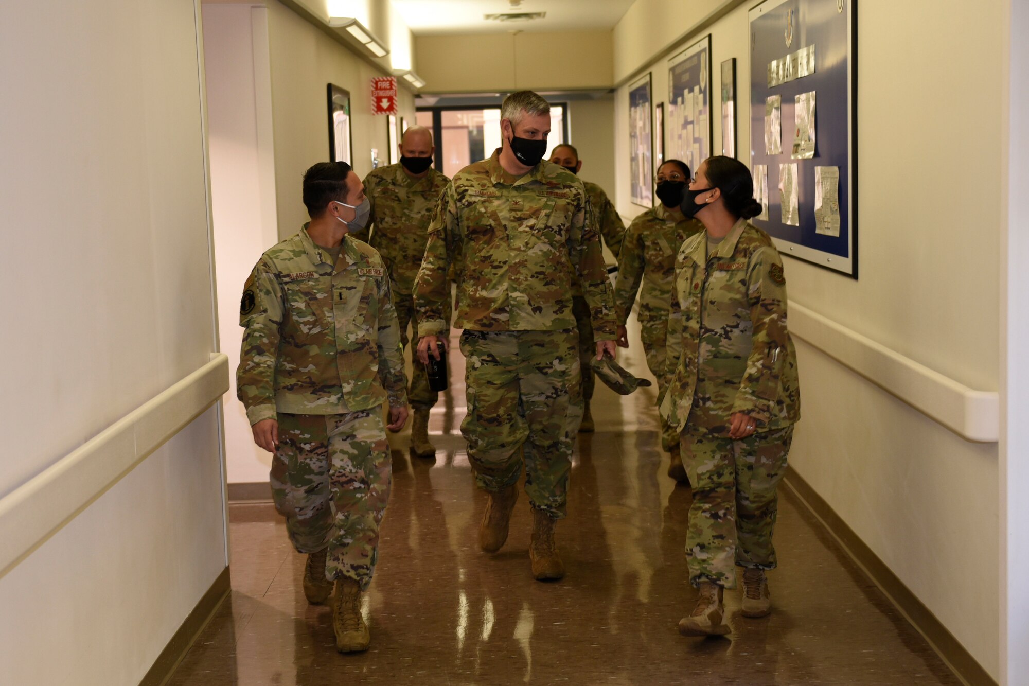 U.S. Air Force 1st Lt. Rodin Anthony, left, 60th Medical Support Squadron TRICARE operations patient administration deputy flight commander, and Maj. Mary Anne, right, 60th MDSS Airmen Medical Transition Unit director lead Col. Corey Simmons, 60th Air Mobility Wing commander, through their work area during Leadership Rounds Aug. 14, 2020, at Travis Air Force Base, California. The Leadership Rounds program provides 60th AMW leadership an opportunity to interact with Airmen and get a detailed view of each mission performed at Travis AFB. (U.S. Air Force photo by Airman 1st Class Cameron Otte)
