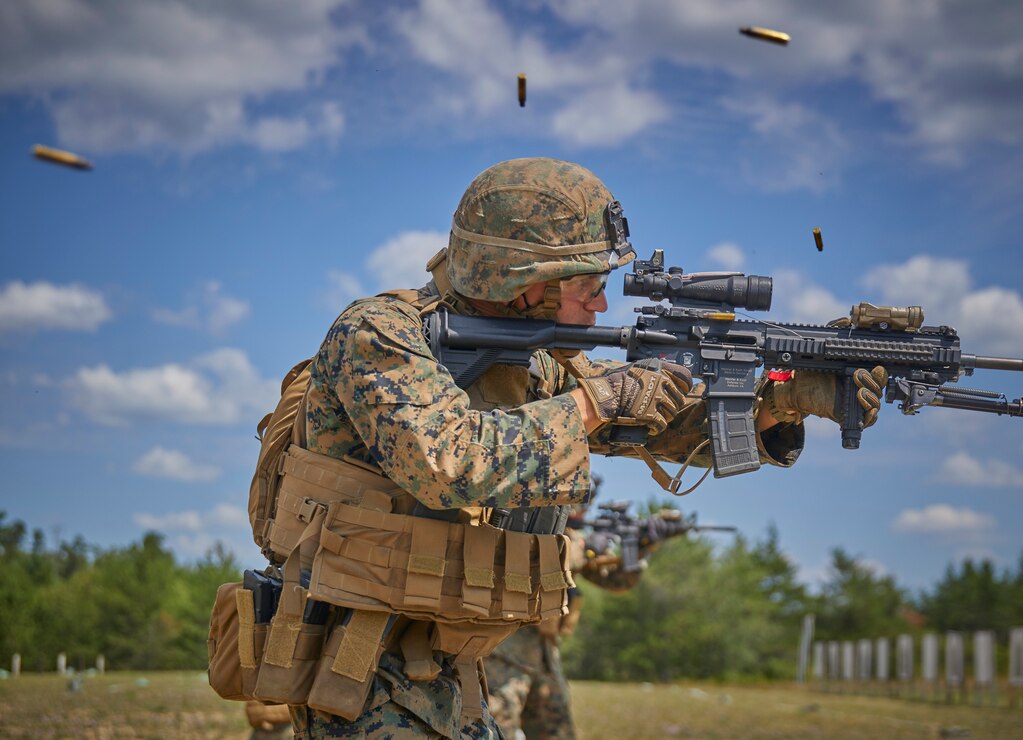 U.S. Marines fire at their targets with M27 Infantry Automatic Rifles during a short-distance range as part of their annual training on Camp Grayling, Mich., Aug. 14.