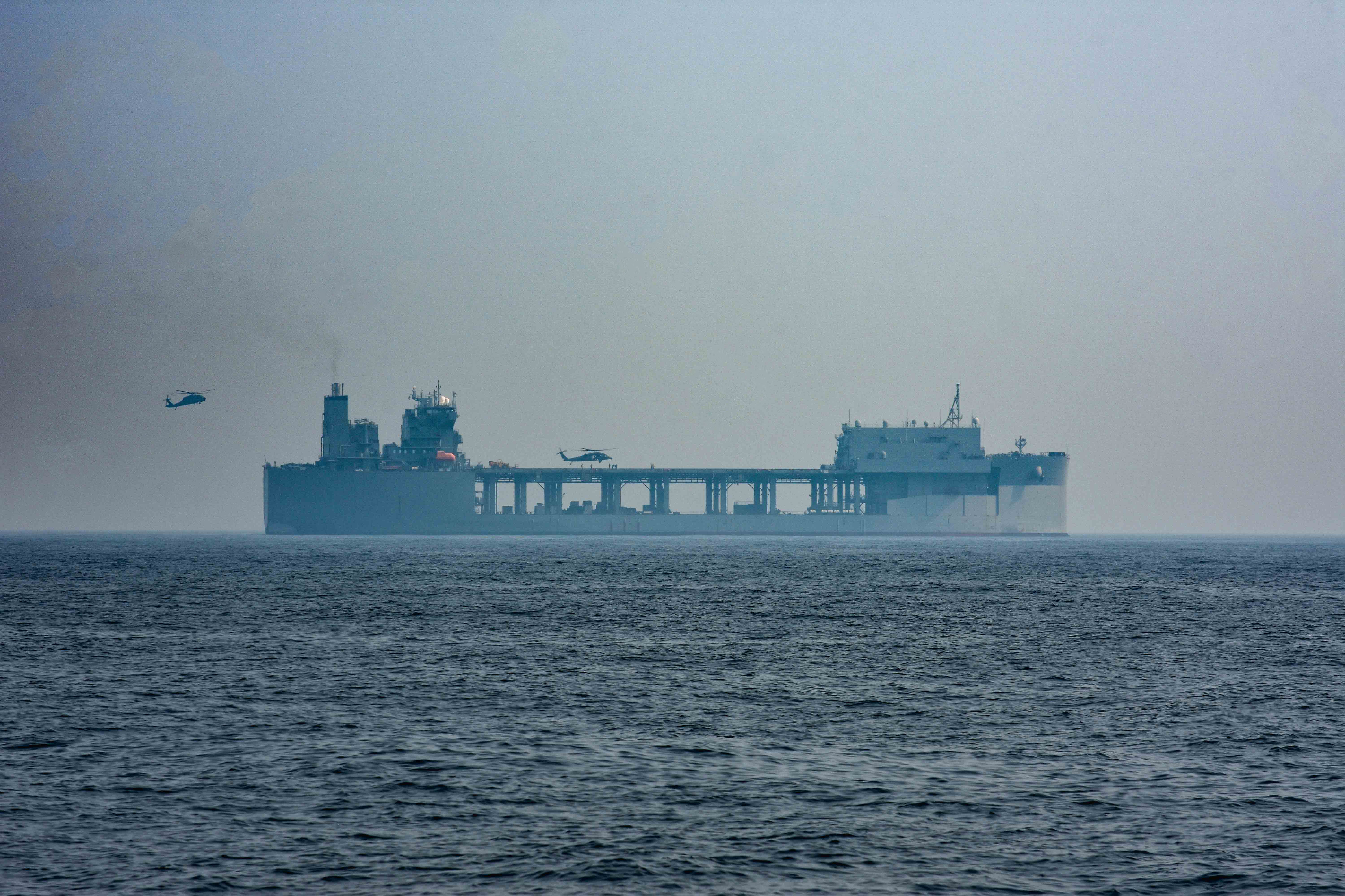 Two UH-60M Black Hawk multi-mission helicopters, attached to United Arab Emirates Joint Aviation Command, land on expeditionary sea base USS Lewis B Puller (ESB 3) during an air operations in support of maritime surface warfare exercise in the Arabian Gulf Aug. 11, 2020. Integration operations between UAE and U.S. maritime forces are regularly held to maintain interoperability and the capability to counter threats posed in the maritime domain, ensuring freedom of navigation and free flow of commerce throughout the region’s heavily trafficked waterways. (U.S. Army photo by Staff Sgt. Timothy Clegg)