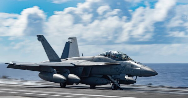 ) An F/A-18F Super Hornet, attached to the "Diamondbacks" of Strike Fighter Squadron (VFA) 102, launches from the flight deck