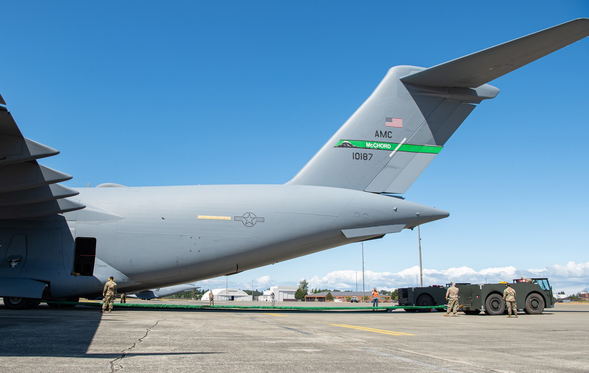 The 62nd Maintenance Squadron Crash Damaged or Disabled Aircraft Recovery (CDDAR) team tow a simulated damaged C-17 Globemaster III during Exercise Long Hammer/Rainier War at Joint Base Lewis-McChord, Wash., Aug. 10, 2020. Along with the CDDAR inject, the 62nd Maintenance Group also conducted engine running offloads during night operations, responded to a simulated aircrew member infected with COVID-19 and more during the exercise. (U.S. Air Force photo by Senior Airman Tryphena Mayhugh)