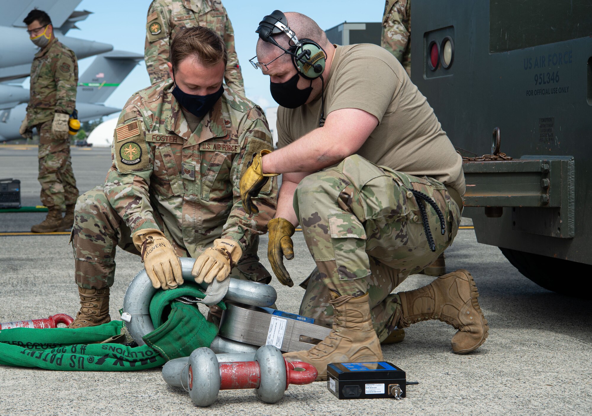 Airmen assigned to the 62nd Maintenance Squadron Crash Damaged or Disabled Aircraft Recovery (CDDAR) team set up the attachment for the towing cable for a simulated damaged C-17 Globemaster III during Exercise Long Hammer/Rainier War at Joint Base Lewis-McChord, Wash., Aug. 10, 2020. Exercises like this maintain Team McChord’s readiness to deploy and operate anywhere anytime. (U.S. Air Force photo by Senior Airman Tryphena Mayhugh)