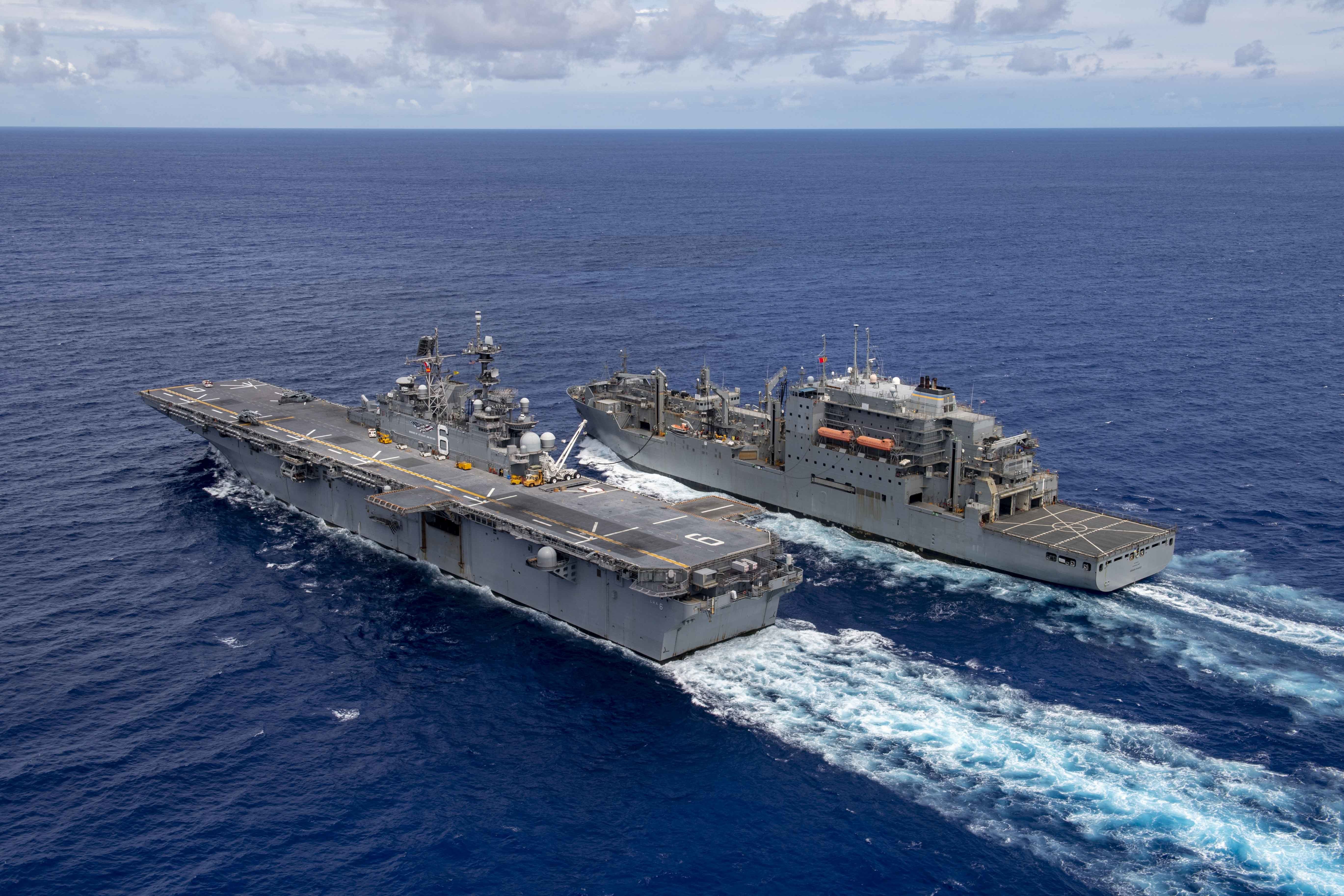 The forward-deployed amphibious assault ship USS America (LHA 6) conducts a replenishment at sea with the dry cargo and ammunition ship USNS Cesar Chavez (T-AKE 14).