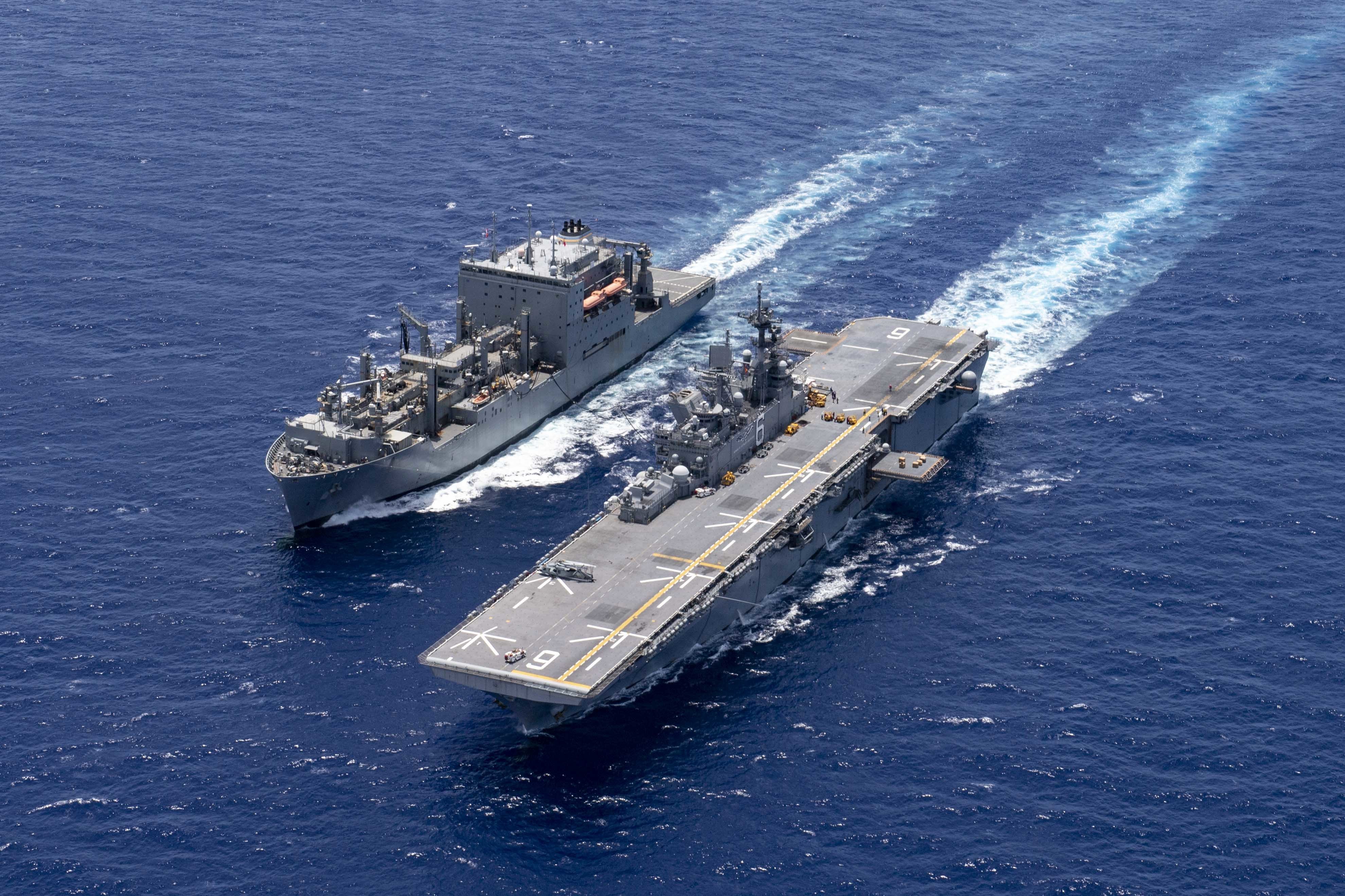 The forward-deployed amphibious assault ship USS America (LHA 6) conducts a replenishment at sea with the dry cargo and ammunition ship USNS Cesar Chavez (T-AKE 14).