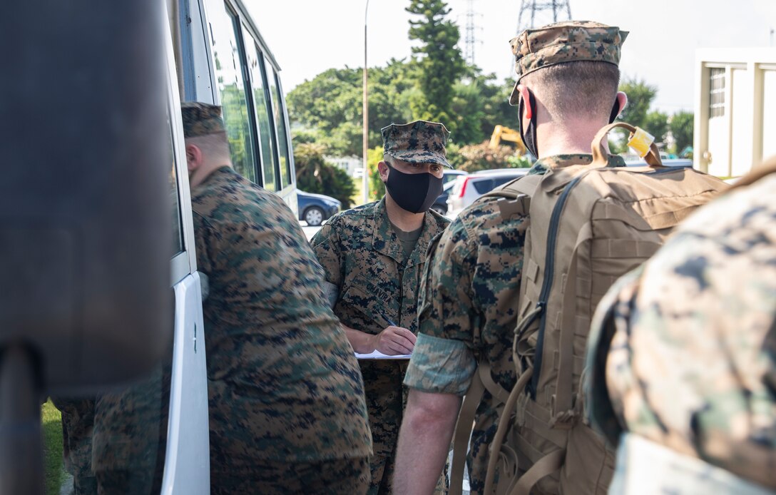 U.S. Marine Gunnery Sgt. Julian Chavira, an administration operations chief with 3d Marine Expeditionary Brigade conducts an accountability check before conducting a flyaway drill at Camp Courtney, Okinawa, Japan, Aug. 18, 2020. The MEB continues to conduct essential, realistic training while adhering to strict COVID-19 safety protocols to mitigate the spread of COVID-19 and are prepared to deploy in support of our allies and partners throughout the region. 3d MEB is structured to rapidly respond to crisis around the globe immediately, effectively, and efficiently, whether they are humanitarian or combat-related.  (U.S. Marine Corps photo by Lance Cpl. Hannah Hall)