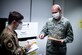 Photo of Airmen sorting through documents