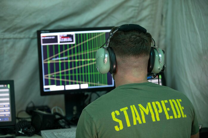 A U.S. Marine observes aircraft coming onto the flight line with a precision approach radar system on MCAS Camp Pendleton, Calif., Aug. 11.