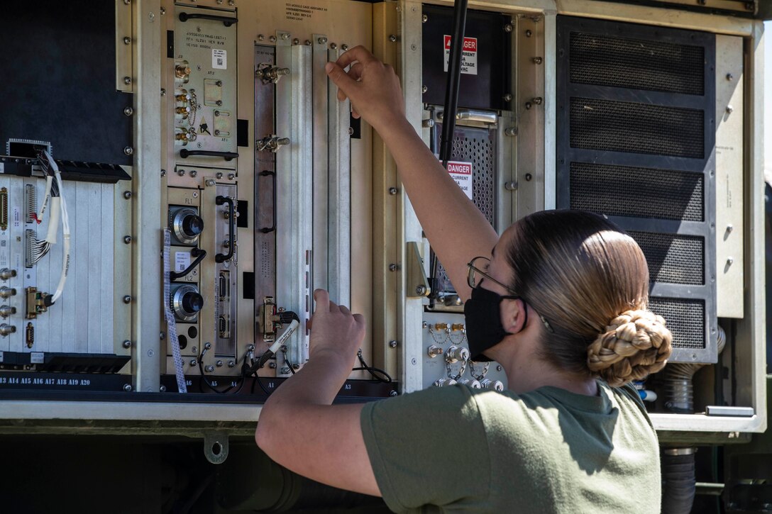 A U.S. Marine looks over an Air Traffic Navigation, Integration and Coordination System on Marine Corps Air Station Camp Pendleton, Calif., Aug. 11.
