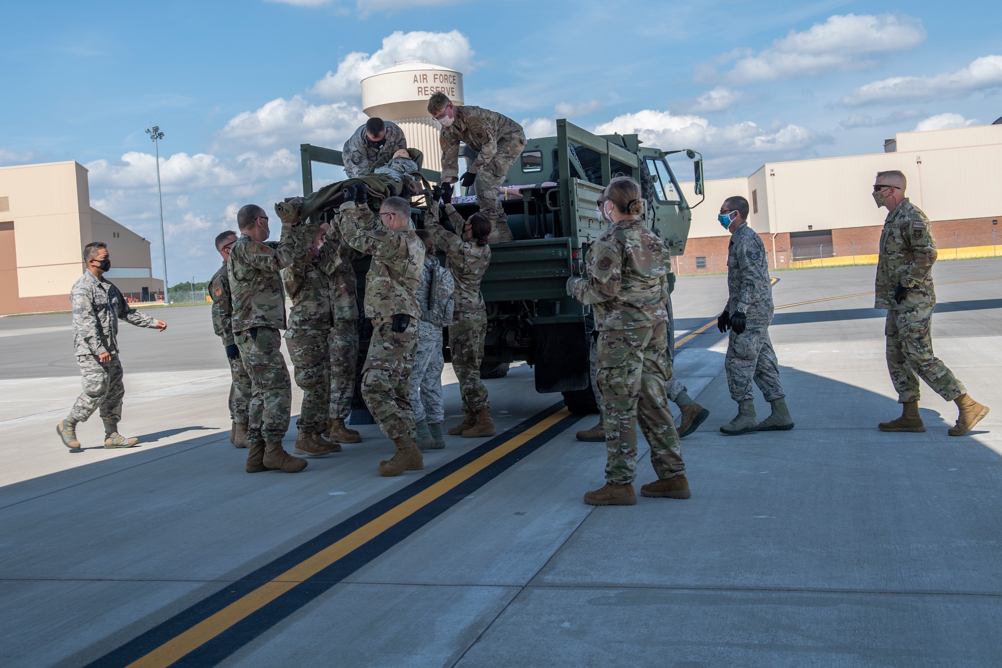Members of the 911th Aeromedical Staging Squadron offload a simulated patient during patient movement training at the Pittsburgh International Airport Air Reserve Station, Pennsylvania, Aug. 11, 2020.