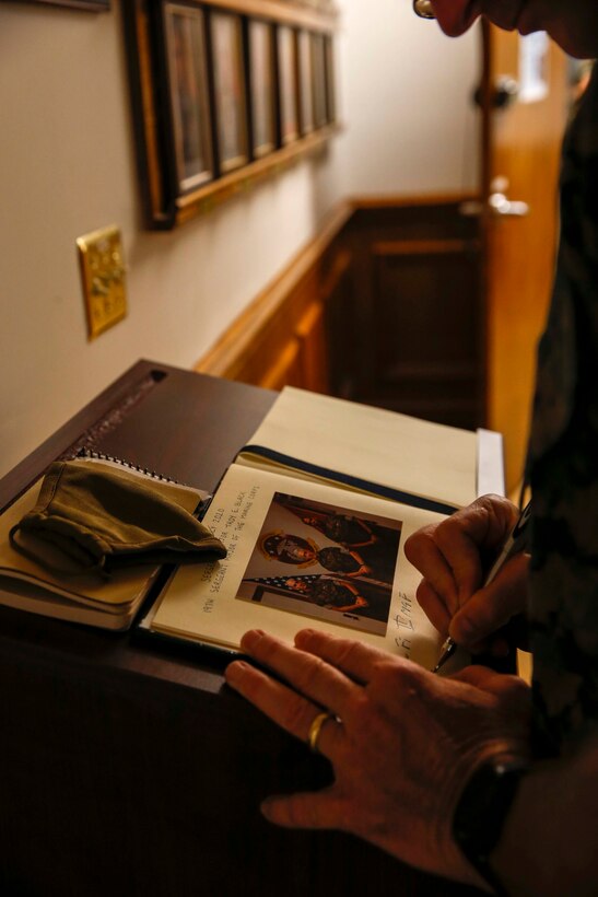 The 19th Sergeant Major of the Marine Corps, Sgt. Maj. Troy E. Black signs the guest book at the II Marine Expeditionary Force (II MEF) headquarters building at Marine Corps Base Camp Lejeune, N.C., July 23, 2020. The II MEF commanding general invited Sgt. Maj. Black in for an office call during his time at Camp Lejeune. The trip was the first of its kind since the start of the COVID-19 pandemic and allowed Sgt. Maj. Black the opportunity to meet with Marines face-to-face. (U.S. Marine Corps photo by Sgt. Victoria Ross)