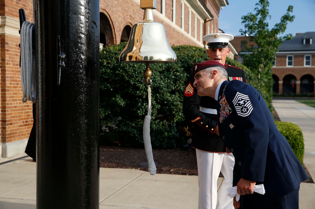 The Senior Enlisted Advisor (SEAC) to the Chairman of the Joint Chiefs of Staff Ramon Colon-Lopez looks at the Nicholas’ ship’s bell presented to the Marine Corps in 1970, prior to the Evening Parade at Marine Barracks Washington, D.C., Aug. 7, 2020. SEAC Colon-Lopez was Sgt. Maj. Black’s guest of honor at the evening’s ceremony. The Parades held every Friday during the summer, have become a universal symbol of the professionalism, discipline, and Esprit de Corps of the United States Marines. (U.S. Marine Corps photo by Sgt. Victoria Ross)