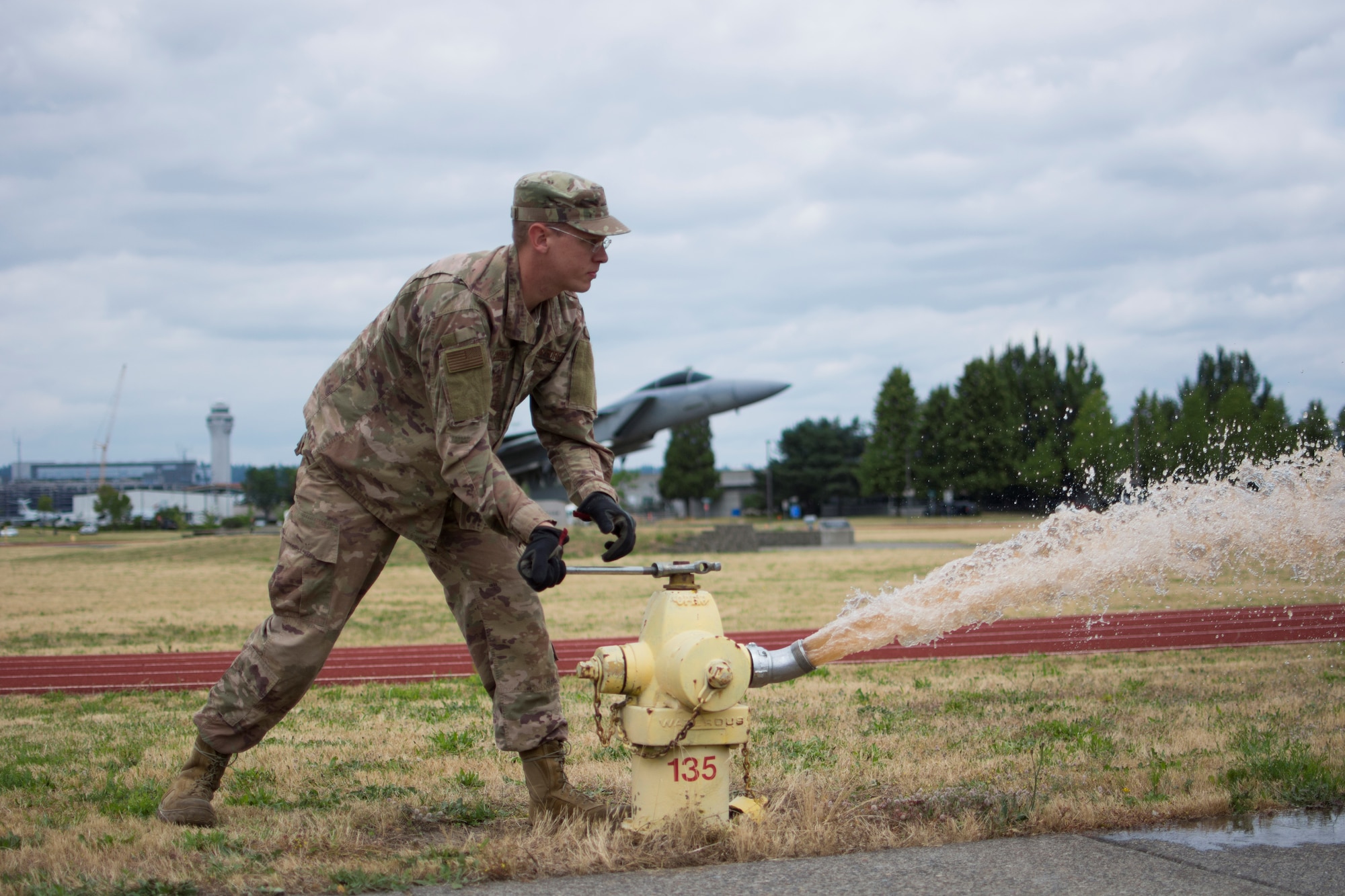 U.S. Air Force Tech. Sgt. Benjamin Schultz, a water and fuels systems maintenance craftsmen from the 142nd Civili Engineer Squadron, Oregon Air National Guard, flushes a hydrant on Portland Air National Guard Base, Ore., July 2, 2020. 
Schultz was selected as the Air National Guard 2020 Outstanding Noncommissioned Officer of the Year. (U.S. Air National Guard photo by Tech. Sgt. Steph Sawyer)