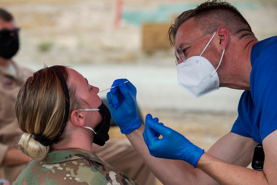 An airman is given a nasopharyngeal swab test.