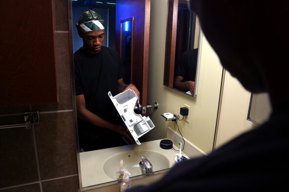 U.S. Air Force Airman 1st Class Chris Robinson, Aerospace Medicine Squadron medical technician, empties a dehumidifier inside Biloxi Hall at Keesler Air Force Base, Aug. 13, 2020. Vending machines and dehumidifiers were provided to the permanent party dorms to improve the health and living standards of the Airmen. (U.S. Air Force photo by Airman 1st Class Seth Haddix)