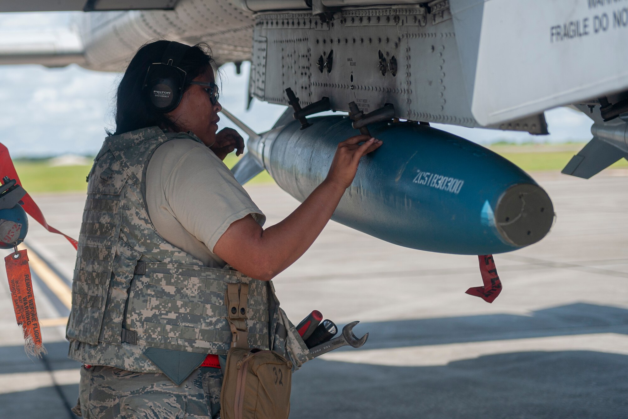 Photo of an Airman loading a munition