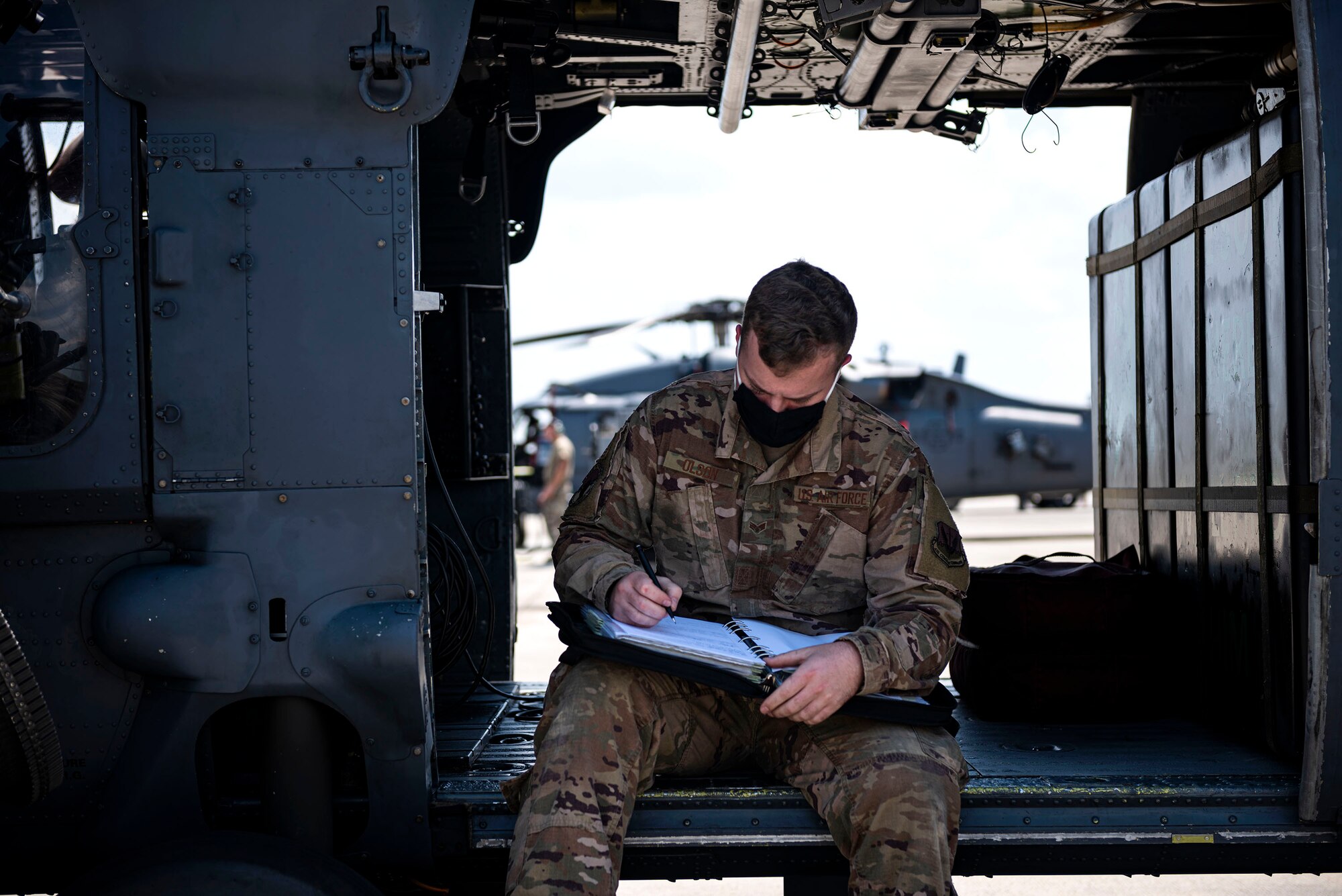 Photo of an Airman signing off on an aircraft form.