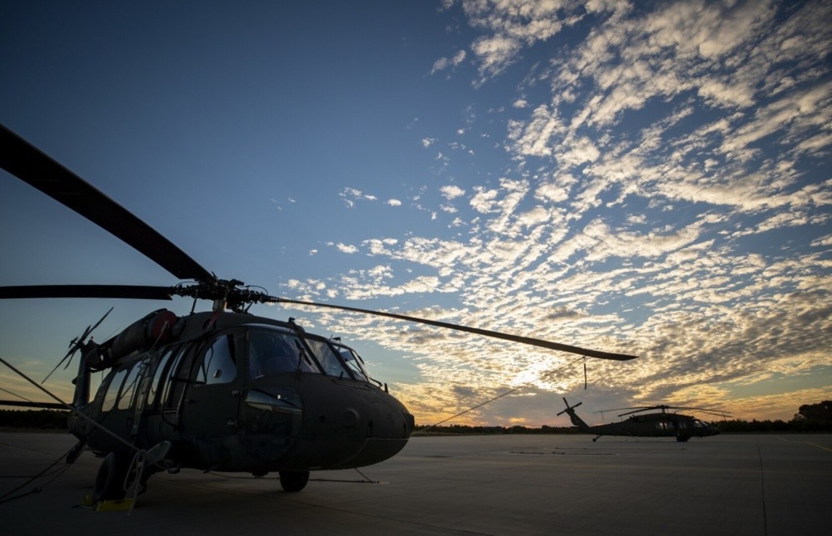 U.S. Army UH-60L Black Hawk helicopters from the New Jersey National Guard’s 1-150th Assault Helicopter Battalion sit on the flight line during sunset at the Army Aviation Support Facility, Joint Base McGuire-Dix-Lakehurst, N.J., Nov. 8, 2018.
