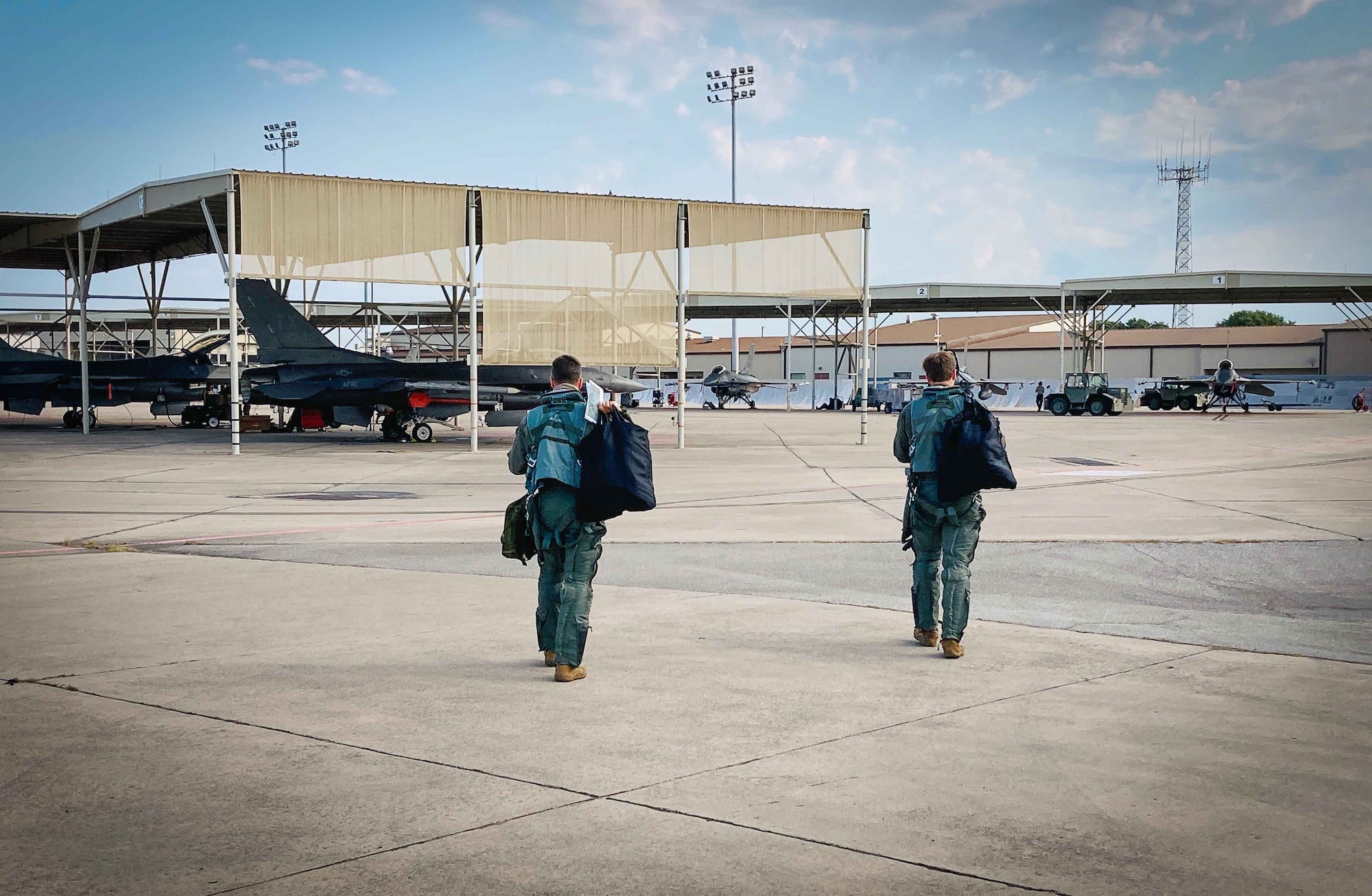 Two F-16 pilots assigned to the 301st Fighter Wing step to their jets prior to the Counter Fast Inshore Attack Craft (C-FIAC) training exercises occurring over Possum Kingdom Lake,Texas August 5 - 12, 2020. For the F-16 Combat Air Force, this training is extremely rare and provided an opportunity to hone a very unique capability to Combatant Commands not traditionally practiced or inherent within U.S. Air Force F-16 mission sets. (U.S. Air Force photo by Master Sgt. Rudy Panacci)