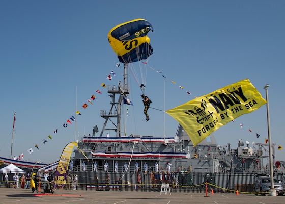 Special Warfare Boat Operator 1st Class Nick Fajardo, a member of the U.S. Navy Parachute Team, the Leap Frogs, comes in for a landing during the decommissioning ceremony for the Mine Countermeasure ship USS Champion (MCM 4).