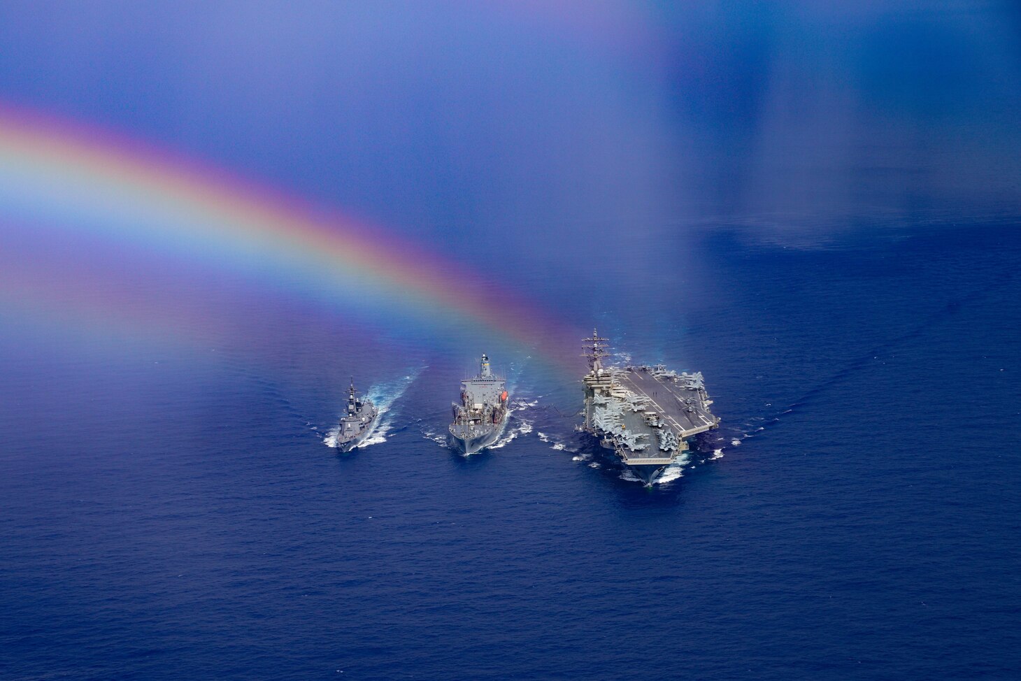 PHILIPPINE SEA (Aug. 16, 2020) (From left) Japanese Maritime Self-Defense Force Murasame-class destroyer Ikazuchi (JS 107), fleet replenishment oiler USNS John Ericsson (T-AO 194) and the Navy’s only forward-deployed aircraft carrier USS Ronald Reagan (CVN 76) steam ahead while conducting a replenishment-at-sea. Ronald Reagan, the flagship of Carrier Strike Group 5, provides a combat-ready force that protects and defends the United States, as well as the collective maritime interests of its allies and partners in the Indo-Pacific region. (U.S. Navy photo by Mass Communication Specialist 3rd Class Jason Tarleton)