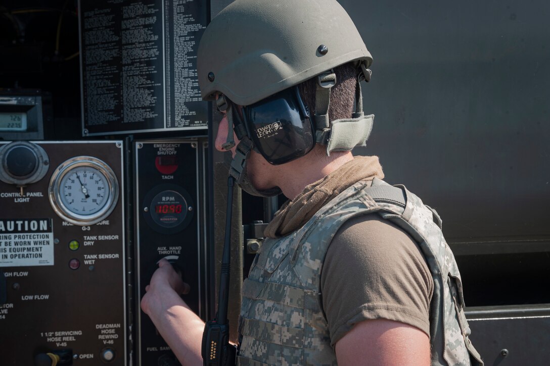 Photo of an Airman checking fuel gauges