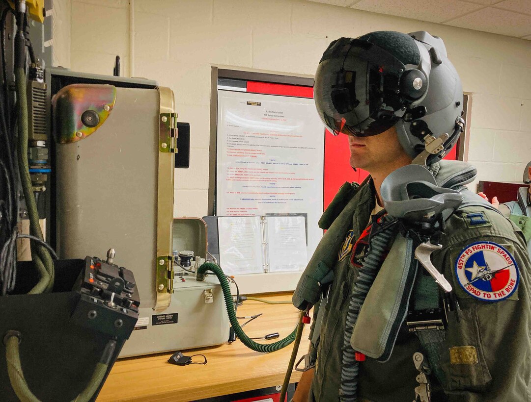 Captain Andy See performs a pre-flight inspection of the Hybrid Optical based Inertial Tracking system (HObIT)at U.S. Naval Air Station Joint Reserve Base Fort Worth, Texas on August 5, 2020. The HObIT system is an electro-optical device that serves as a heads up display in the pilot’s right eye. (U.S. Air Force photo by Master Sgt. Rudy Panacci)