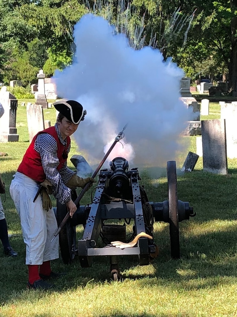 A member of the Sons of the American Revolution fires off three cannon volleys during the grave-marking ceremony honoring Claudius Britton II and III at the Pinckney Cemetery Aug. 8, 2020.