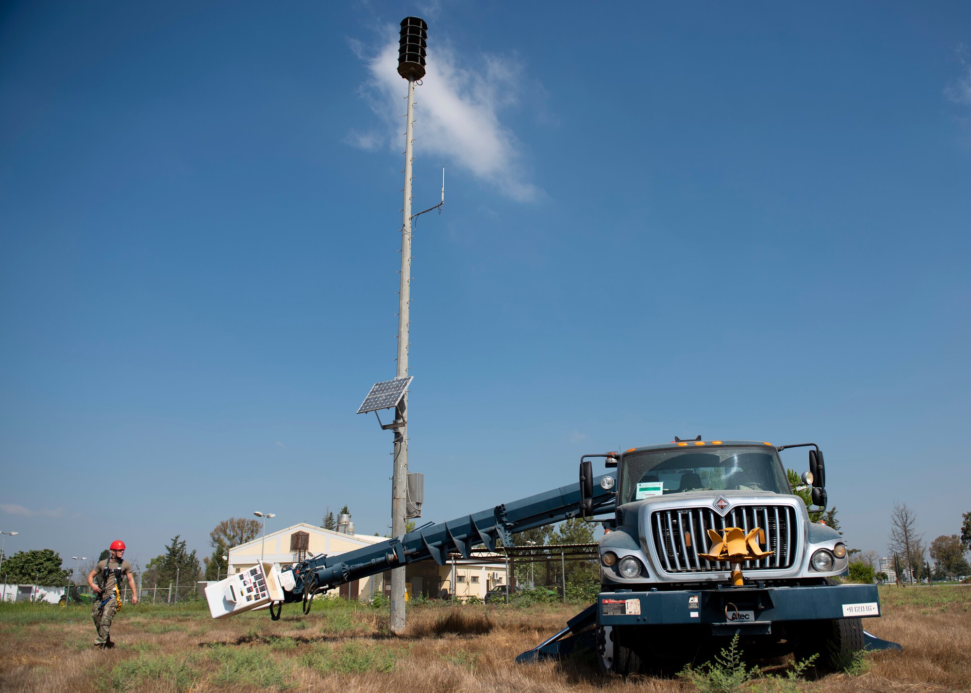 Senior Airman Noah Dray helps guide a bucket truck lift-arm back to its retracted position near a loud speaker tower at Incirlik Air Base, August 12, 2020.