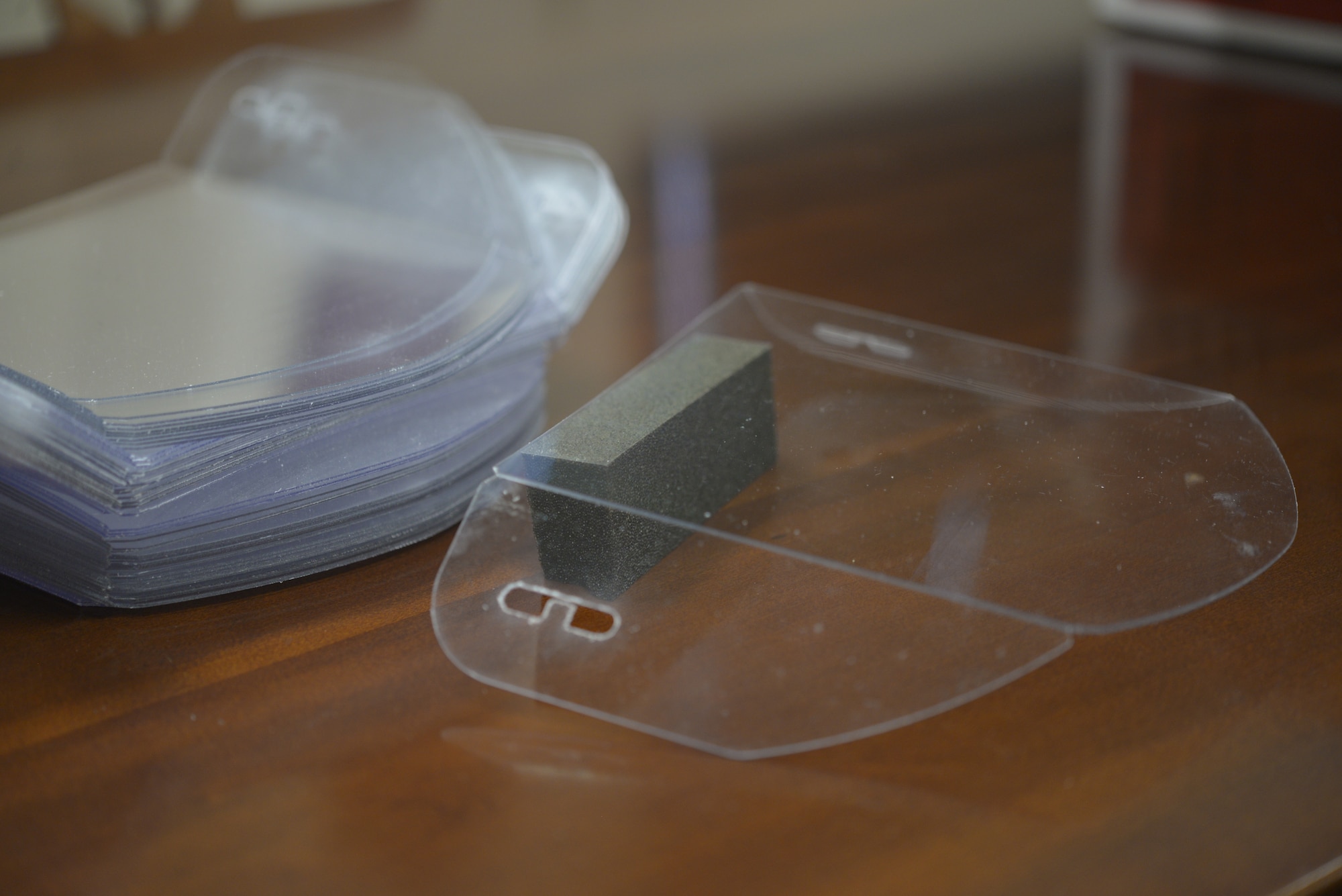 A plexiglass face shield is displayed in the Trainer Development Center at Keesler Air Force Base, Mississippi, Aug. 12, 2020. The development center crafted 1,500 face shields over six days using a template provided by the Jackson County School District's FabLab, composed of high schoolers from the district. (U.S. Air Force photo by Airman 1st Class Kimberly L. Mueller)