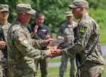 New York Army National Guard Staff Sgt. Matthew Ortiz, right, who finished first in the noncommissioned officer division at the Army Guard Northeast Best Warrior Competition at Camp Ethan Allen in Jericho, Vermont, receives his award from Vermont Army National Guard Command Sgt. Maj. Nathan Chipman, Aug. 16, 2020. Ortiz is the third New York Army National Guard NCO in a row to win this award.