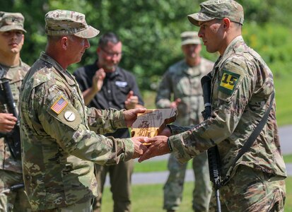 New York Army National Guard Staff Sgt. Matthew Ortiz, right, who finished first in the noncommissioned officer division at the Army Guard Northeast Best Warrior Competition at Camp Ethan Allen in Jericho, Vermont, receives his award from Vermont Army National Guard Command Sgt. Maj. Nathan Chipman, Aug. 16, 2020. Ortiz is the third New York Army National Guard NCO in a row to win this award.