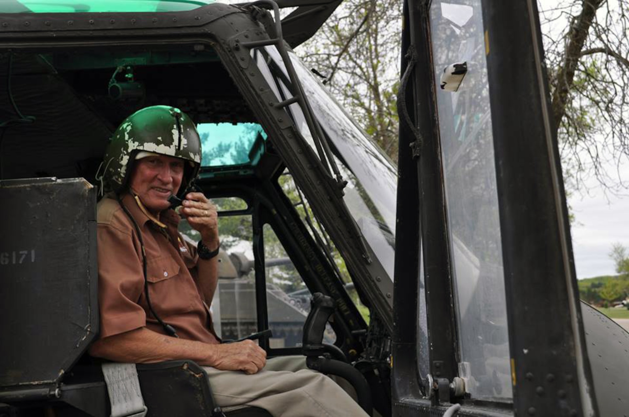 Lt Col. (Ret.) Eustice Shiver sitting in cockpit of Huey 66-16171