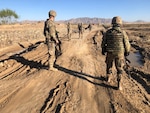 Sgt. Douglas King of the Wisconsin Army National Guard's 829th Engineer Company assesses a road repair project in Afghanistan with a Romanian soldier in April 2020. Approximately 150 Soldiers from the 829th Engineer Company are deployed across the Middle East and Southwest Asia.
