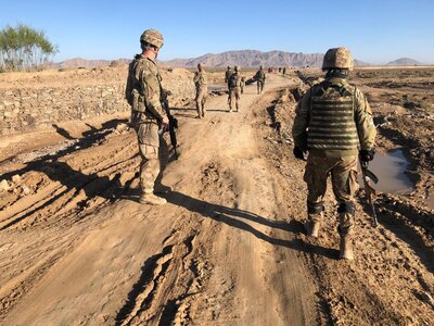 Sgt. Douglas King of the Wisconsin Army National Guard's 829th Engineer Company assesses a road repair project in Afghanistan with a Romanian soldier in April 2020. Approximately 150 Soldiers from the 829th Engineer Company are deployed across the Middle East and Southwest Asia.