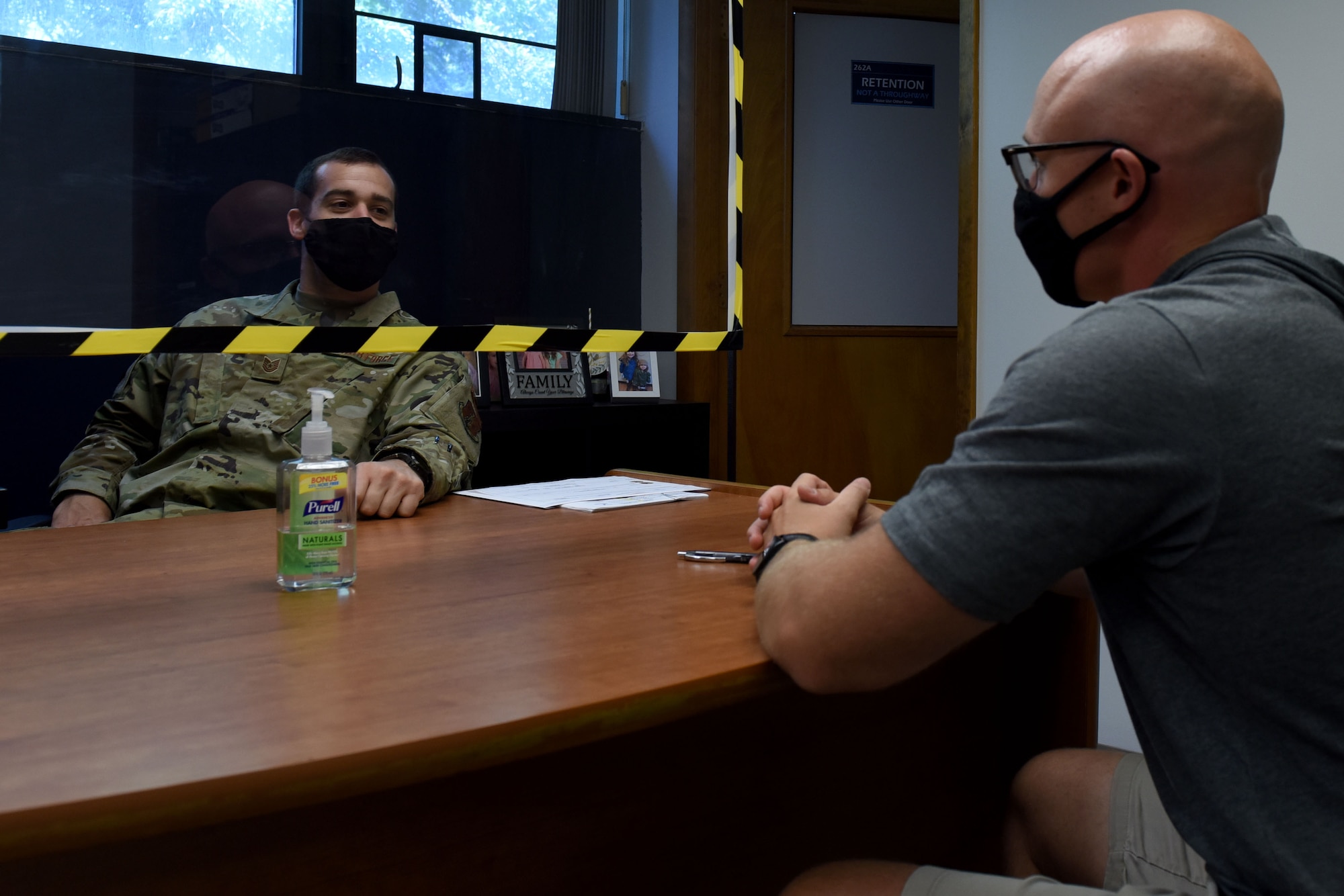 Tech. Sgt. Alex Wagner, a Production Recruiter, speaks with an incoming Airman at the 171st Air Refueling Wing in Coraopolis, Pa. Aug. 17, 2020. In response to COVID-19, the 171st implemented stringent safety and health protocols. (U.S. Air National Guard Photo by Staff Sgt. Kyle Brooks)